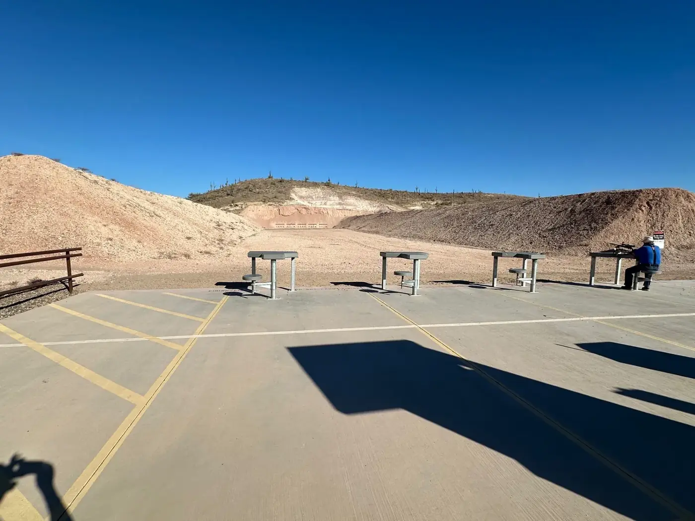 Shooting tables at a free public BLM shooting site in Arizona under a clear sky